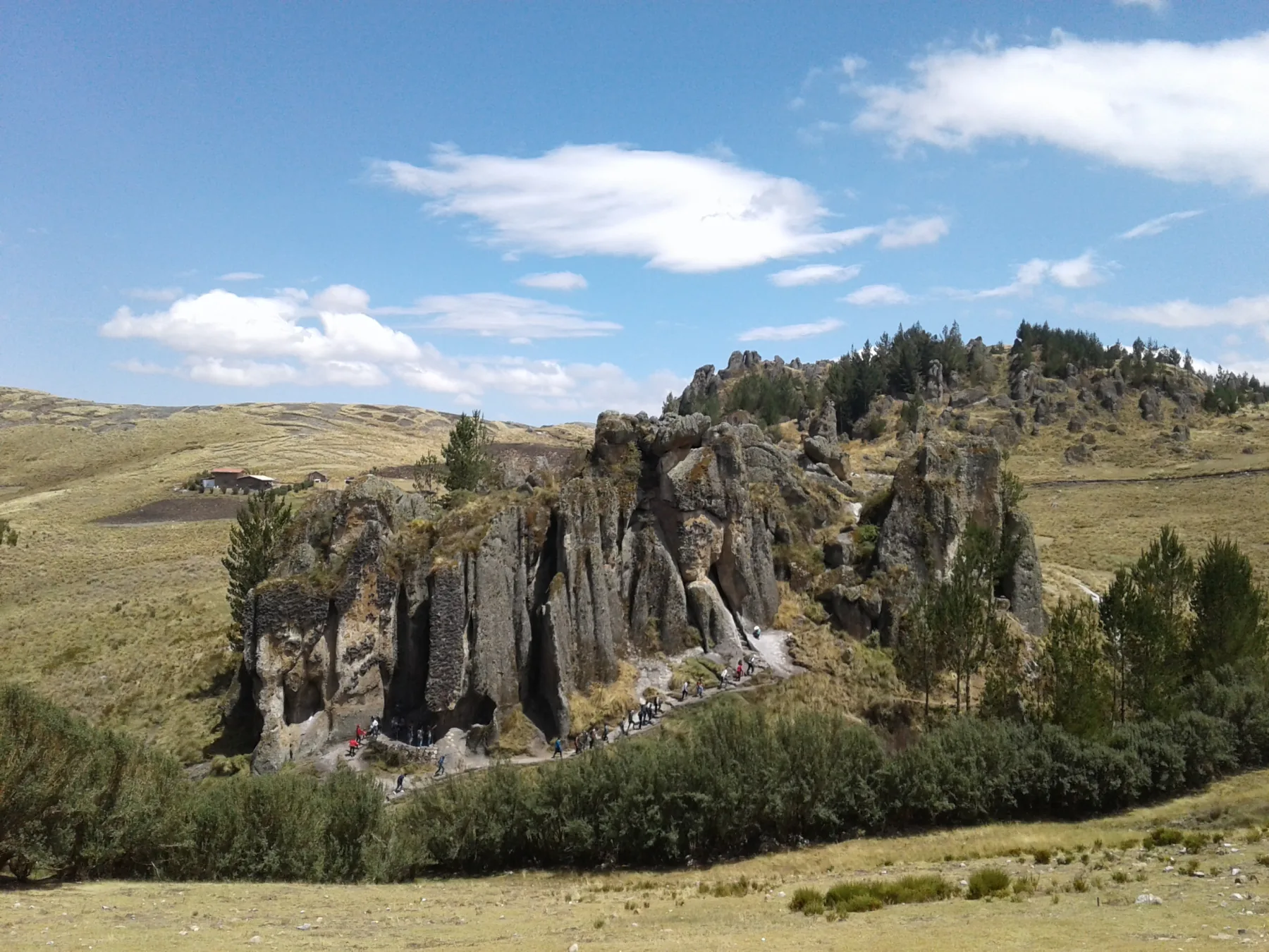 Rock formations at Cumbemayo in the Cajamarca region, with small figures on the path.